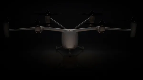 A black plane with six tilting propellers on a black background.