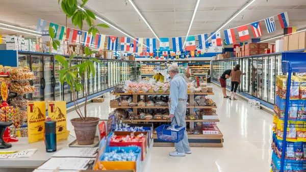 Interior photo of an international grocery store, with mini flags from dozen of countries hanging from the ceiling