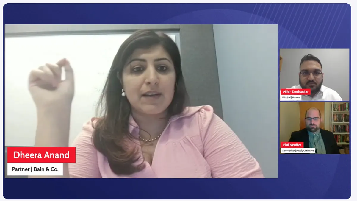 Three people are on a screen during a panel discussion, framed by banners with the corresponding name and titles.