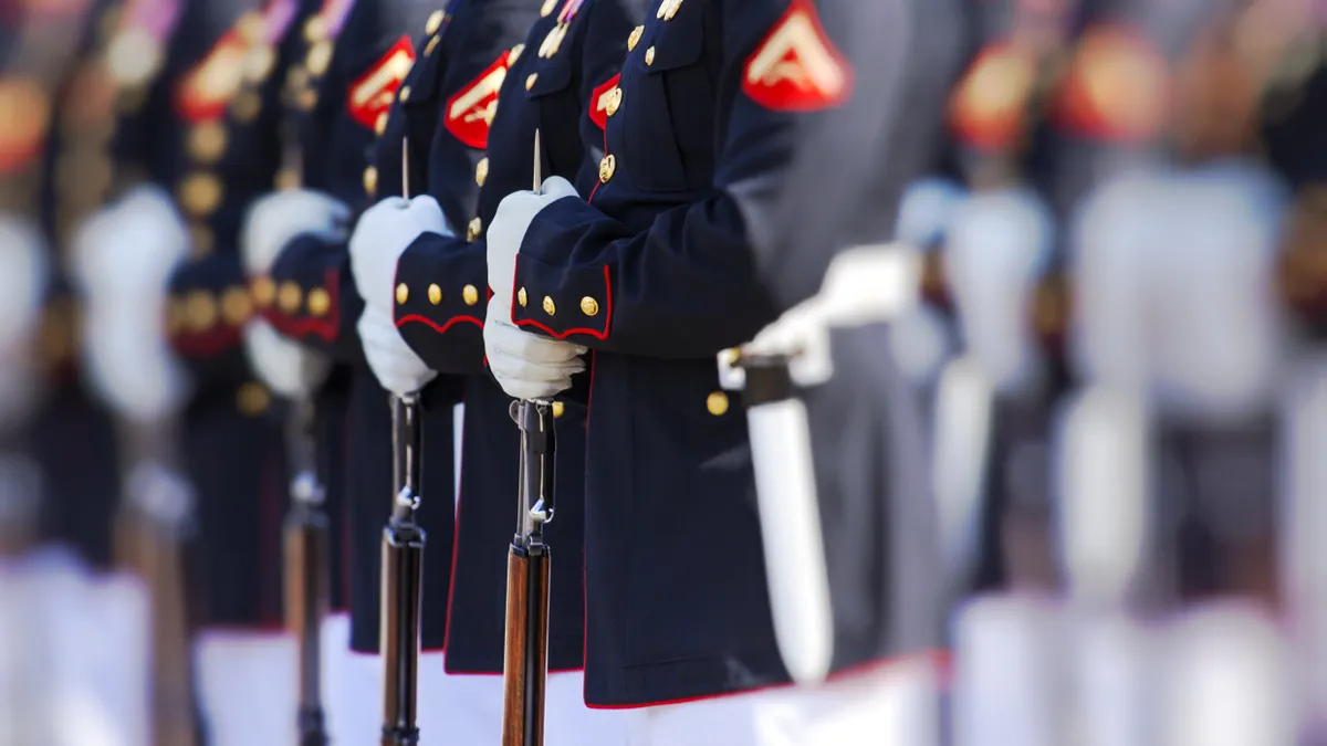 Marines stand in profile in a focused picture.