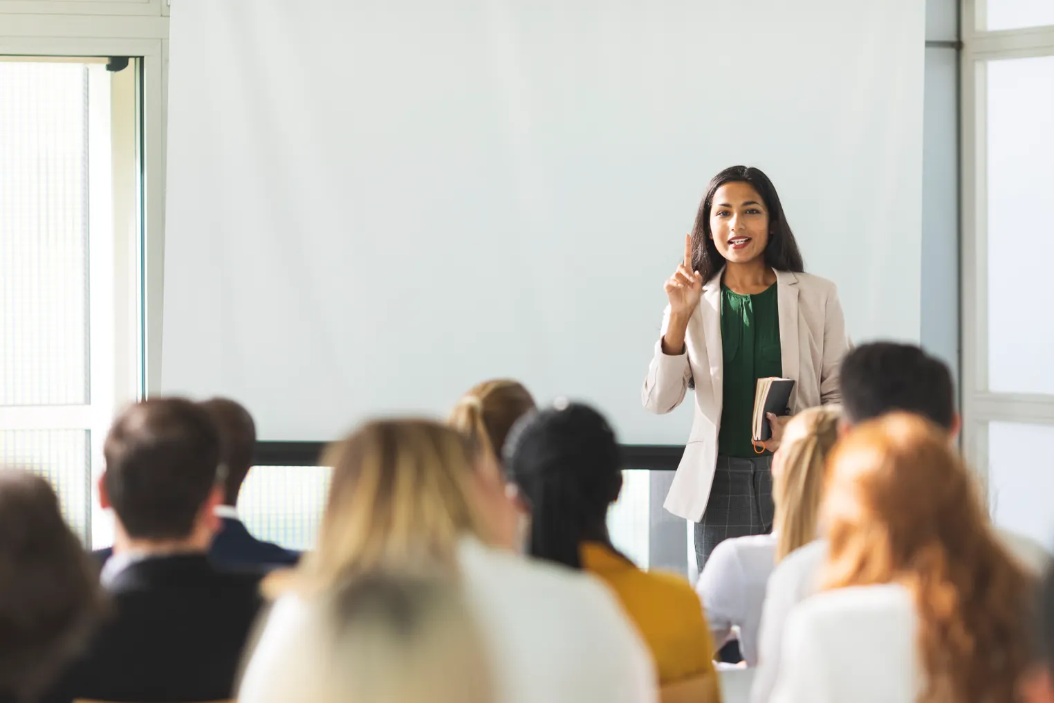 Businesswoman of Indian descent speaking at a seminar.