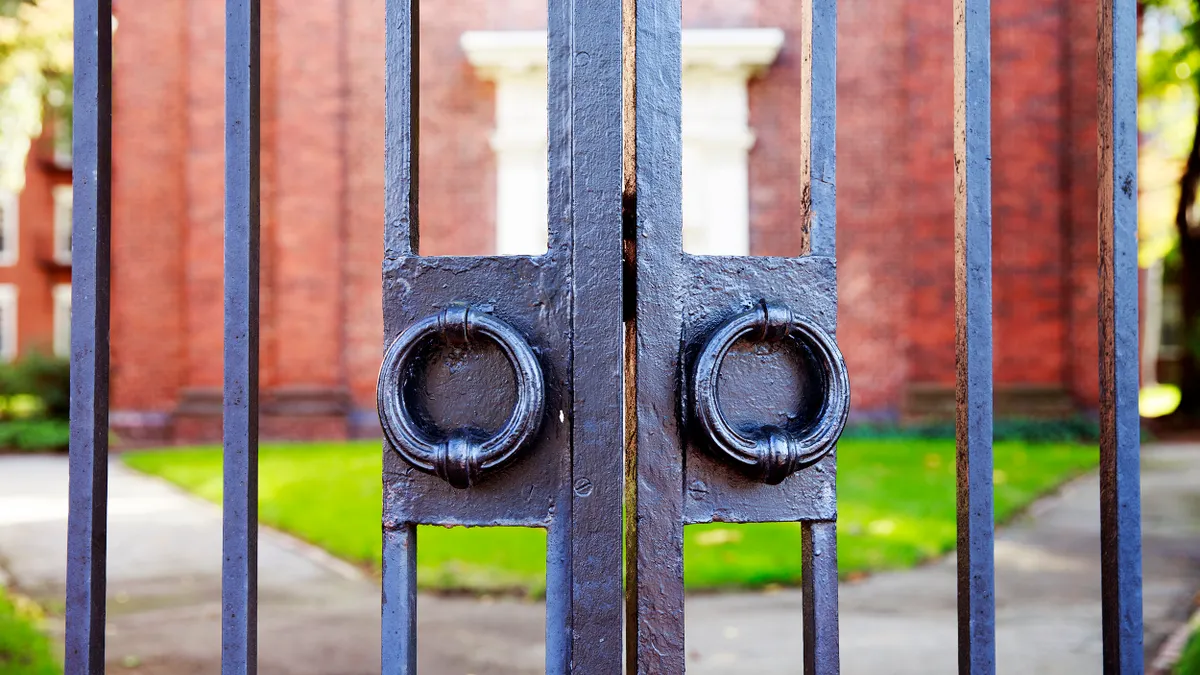 Image of college campus gate, closed.