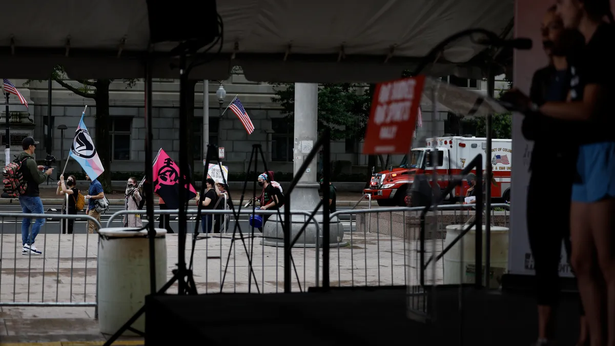 Transgender rights activists protest outside a "Our Bodies, Our Sports" rally.