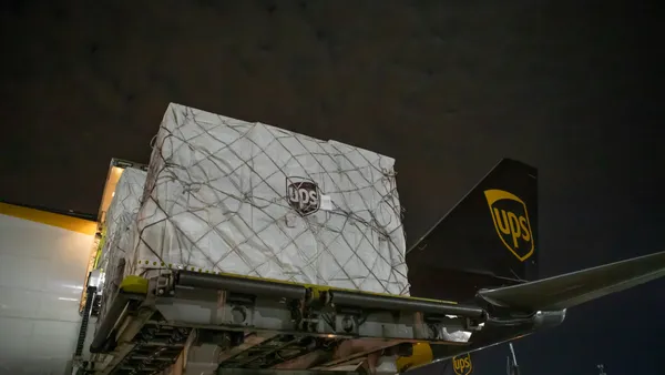 UPS cargo being loaded or unloaded from an airplane