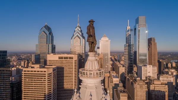 A view of the skyline of Philadelphia, with the bronze statue of William Penn in the foreground