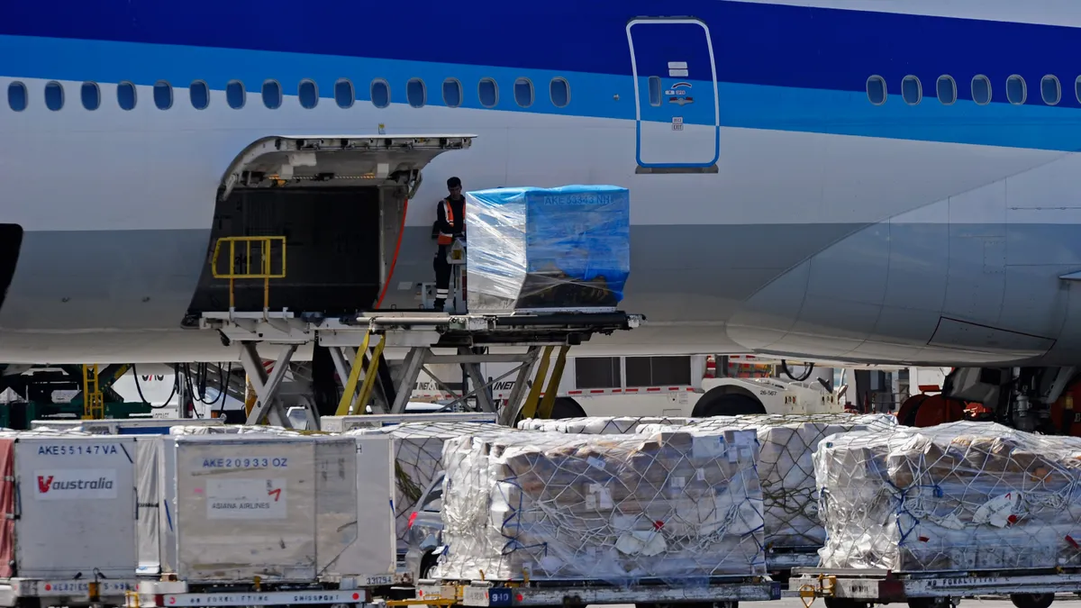 Airline workers load cargo into an All Nippon Airways passenger plane at Los Angeles International Airport on October 30, 2010 in Los Angeles, California.