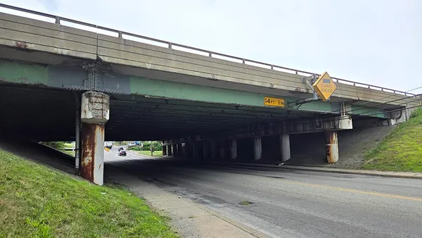 A simple open bridge over a roadway.