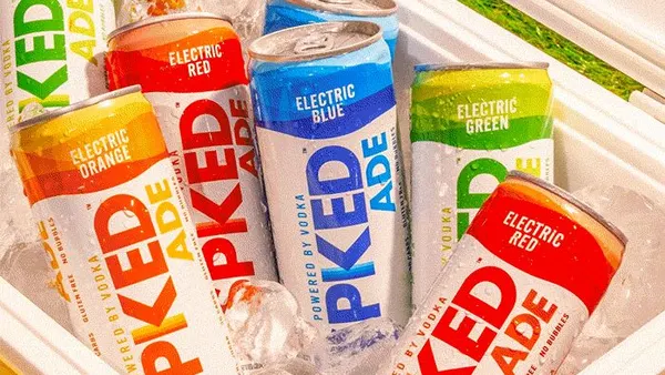 Cans of Spiked Ade are in a cooler around ice.