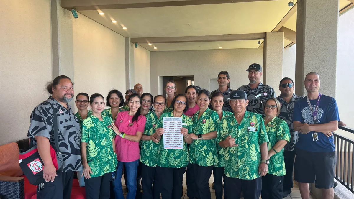 Workers pose together for a photo.