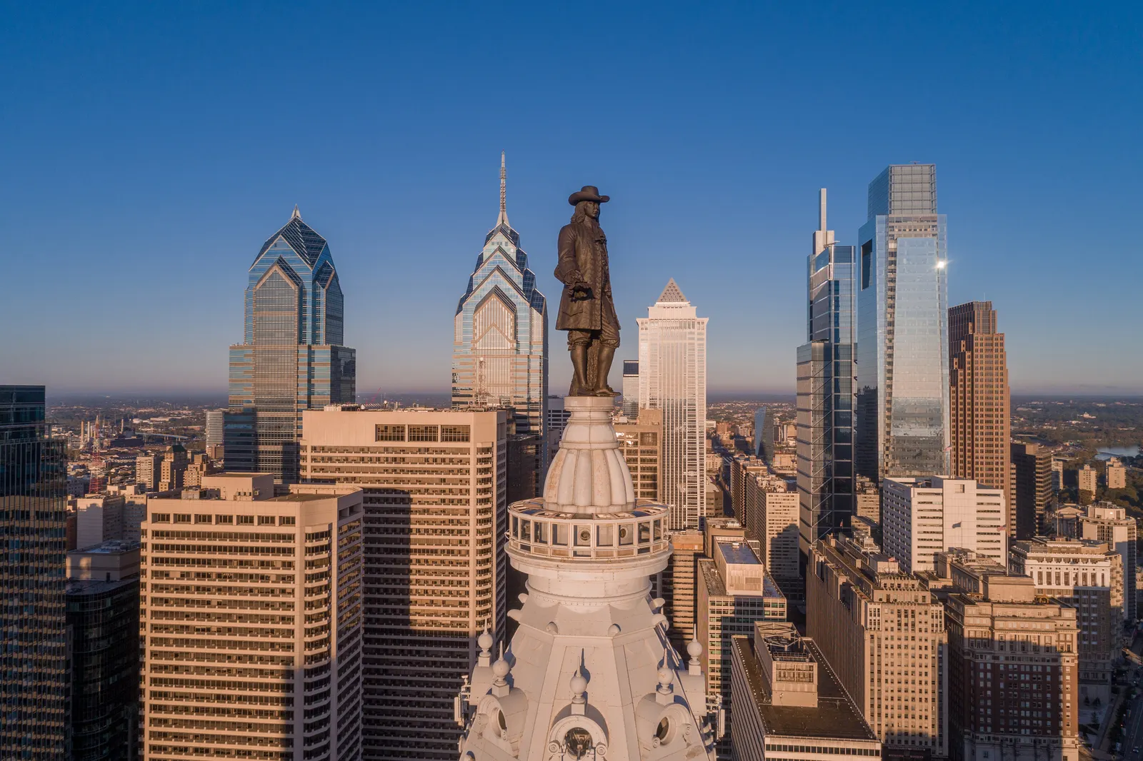 A view of the skyline of Philadelphia, with the bronze statue of William Penn in the foreground