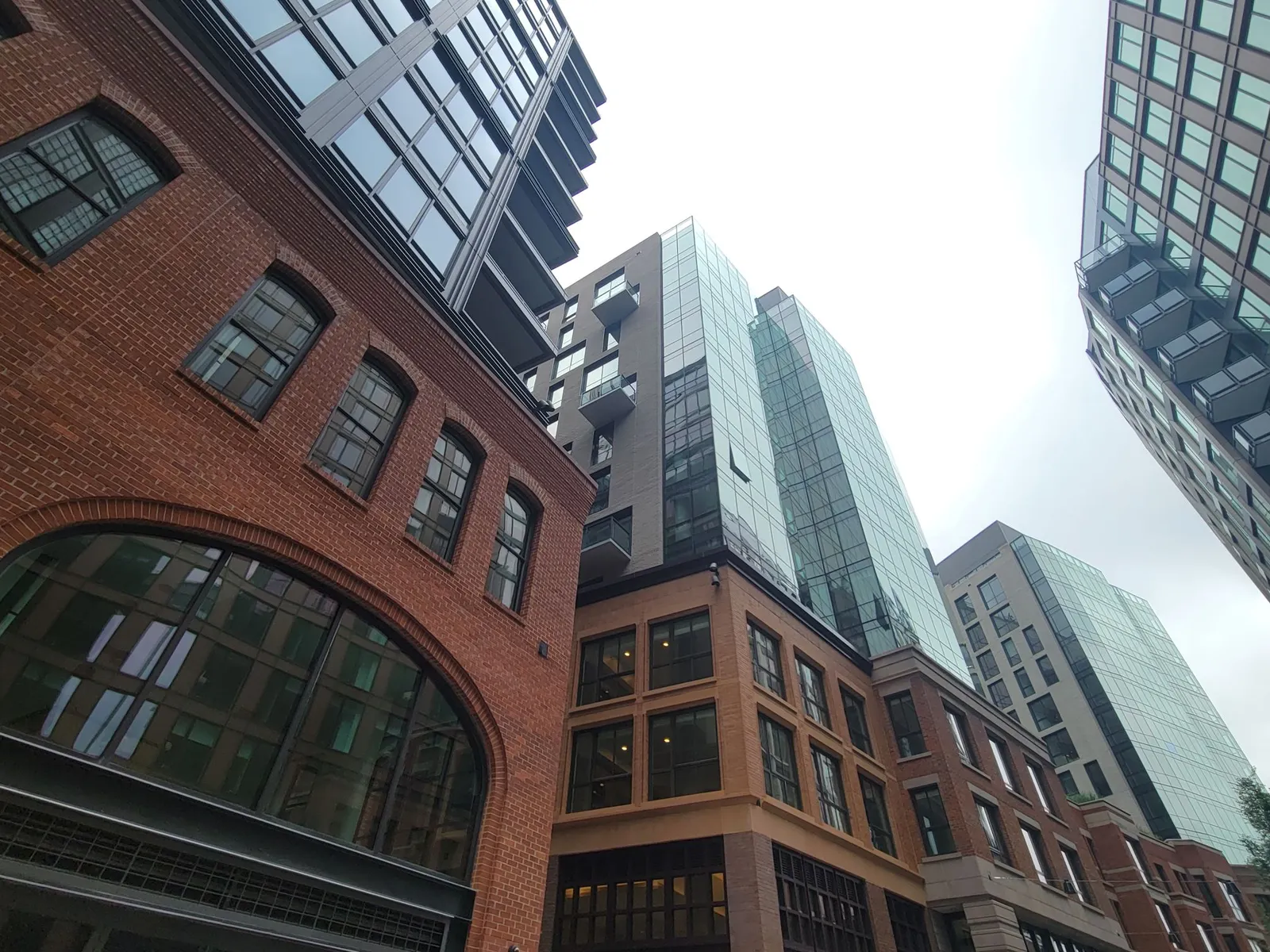 Three buildings with brick bases.