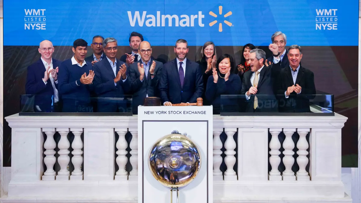 Walmart International chief financial officers, led by Walmart Inc. CFO John David Rainey, at the podium, ring the NYSE opening bell.