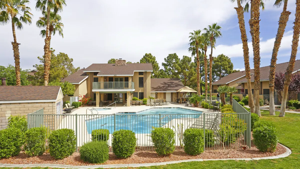 Pool with brown apartments in the background