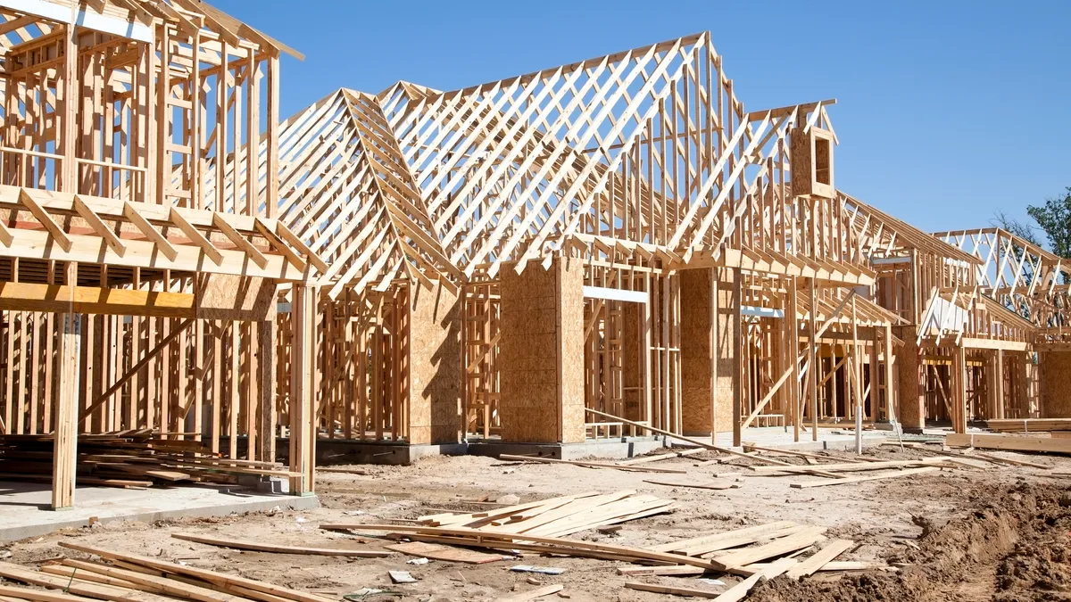 New homes construction site. Framed houses. Lumber. Building. - stock photo.