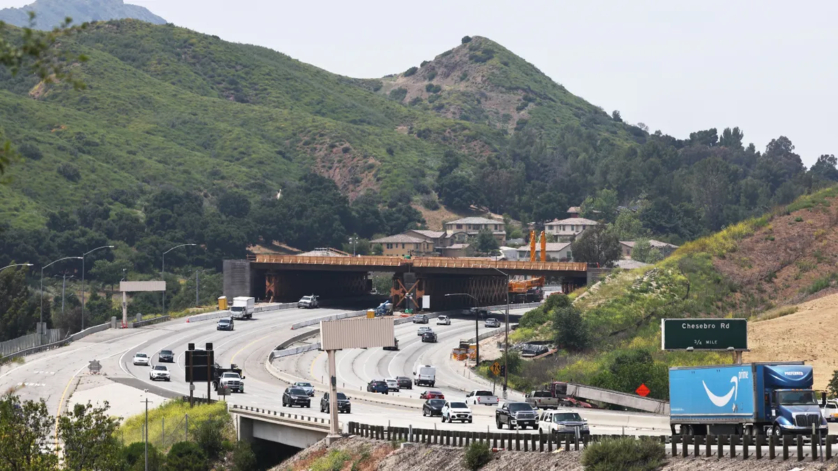 The 165-foot wide crossing, scheduled to be completed in 2026, will blend into the surroundings and allow wildlife to roam above the busy freeway where up to 300,000 vehicles pass daily.