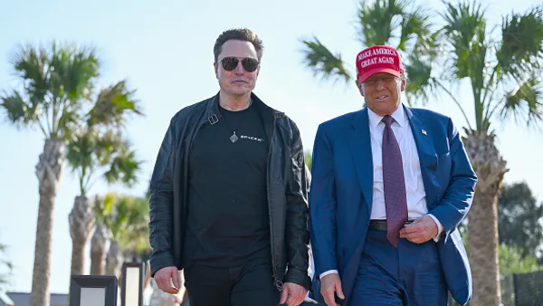 U.S. President-elect Donald Trump greets Elon Musk.