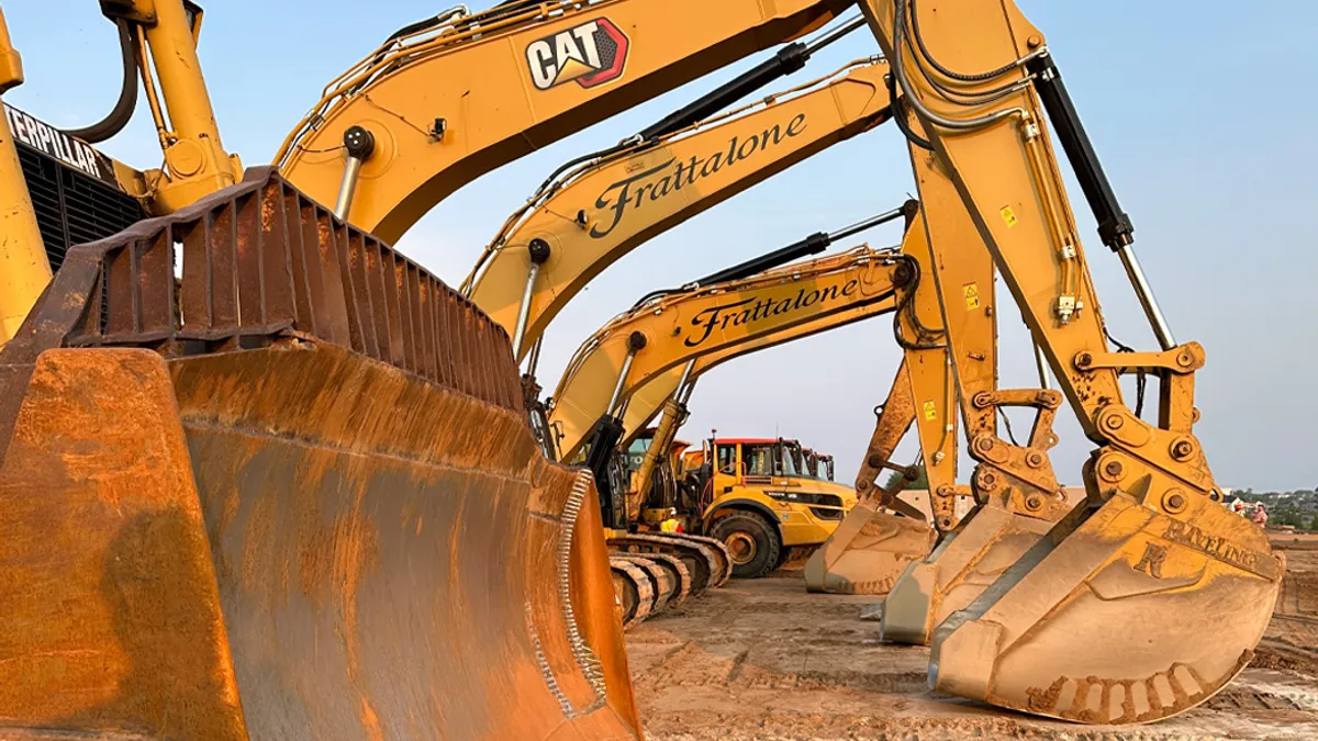 Excavators lined up at a construction site.