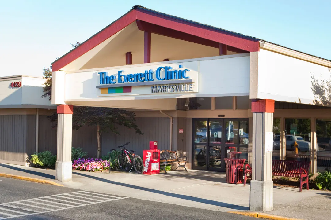 A modern commercial building with a large logo reading "The Everett Clinic, Marysville" at the top of the entrance.