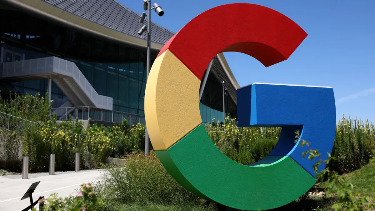 The Google "G" logo is displayed in front of a building.