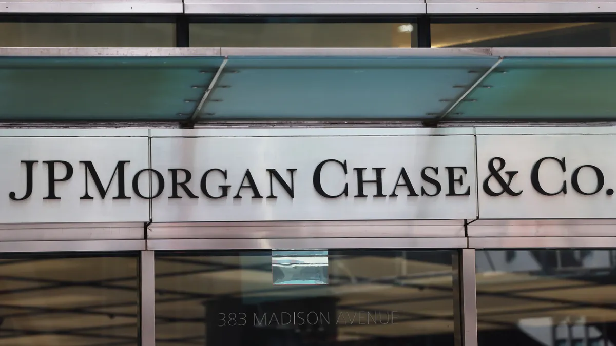 A logo reading "JPMorgan Chase & Co." hangs over a set of doors