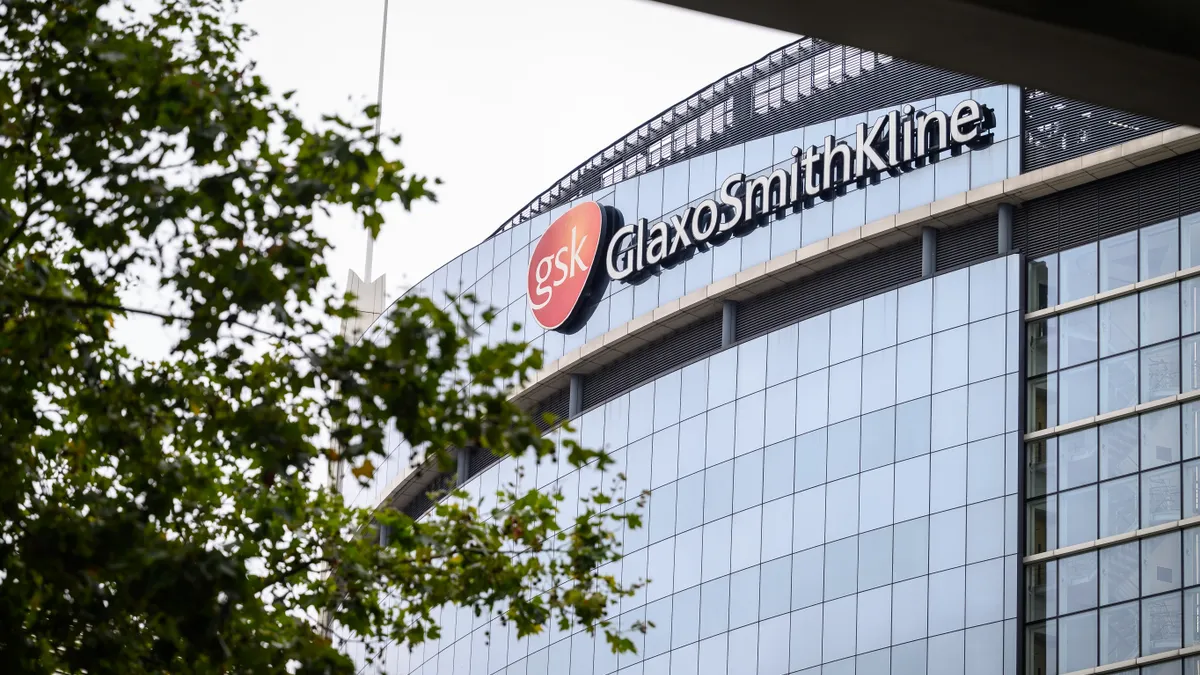 A office building is seen with a sign reading "GlaxoSmithKline."