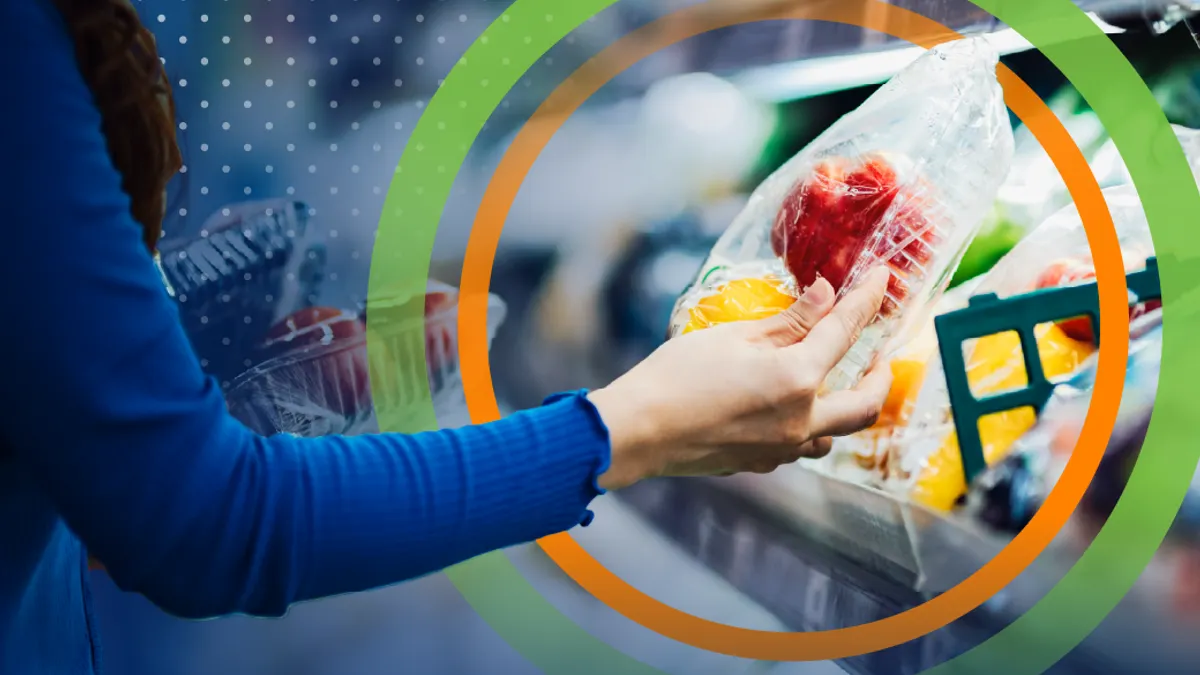 Person holding plastic container of grocery store fruit
