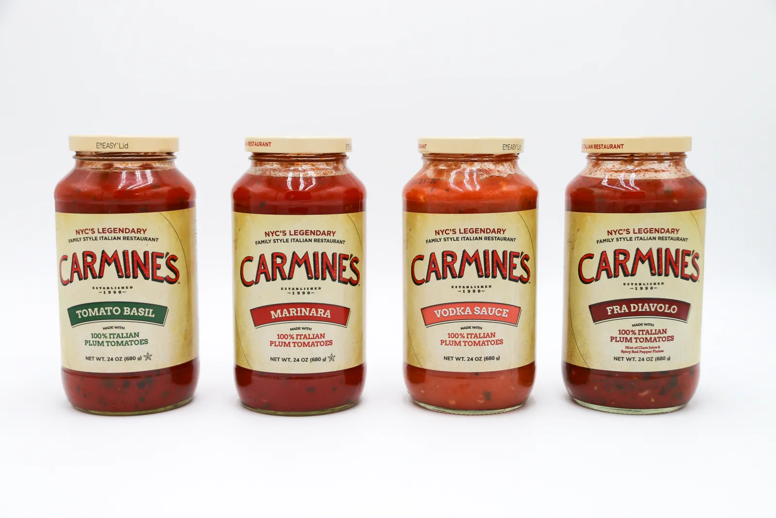 Four jars of Carmine&#x27;s Italian sauces with lids that say &quot;Eeasy Lid.&quot;