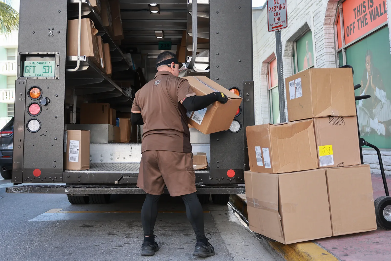 A UPS driver makes a delivery on January 30, 2024 in Miami Beach, Florida.