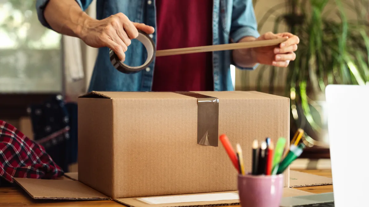 A customer prepares a box for a return