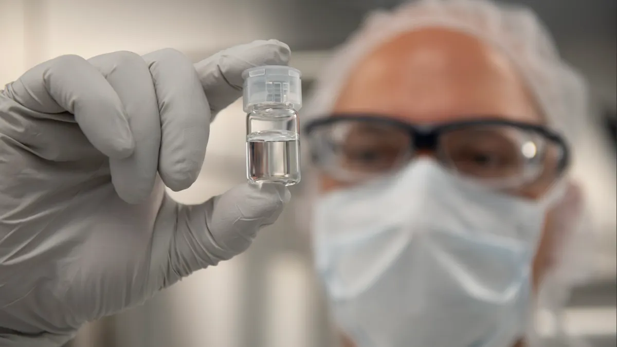 Person holding a vial
