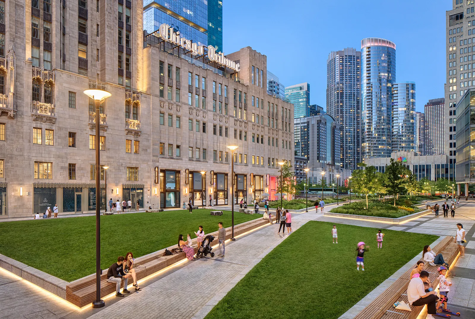 A courtyard around a building with a sign that reads &quot;Chicago Tribune.&quot;