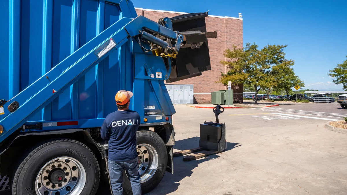 A Denali worker collecting waste from a Walmart store in Denver.