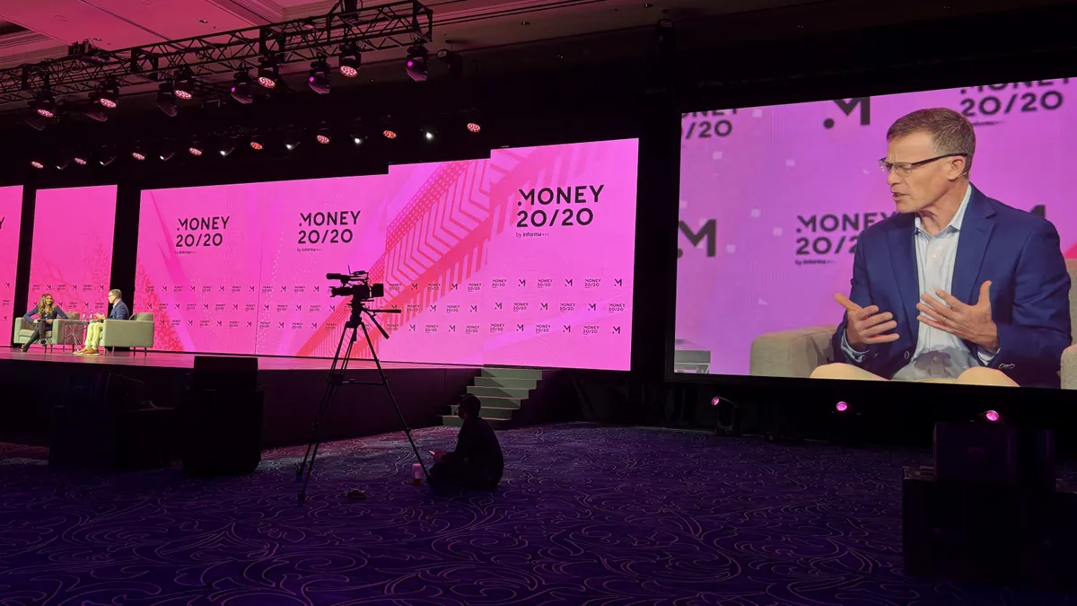 Tim Ryan, Citi's head of technology and business enablement, is shown on a big screen while he speaks on stage at a conference.