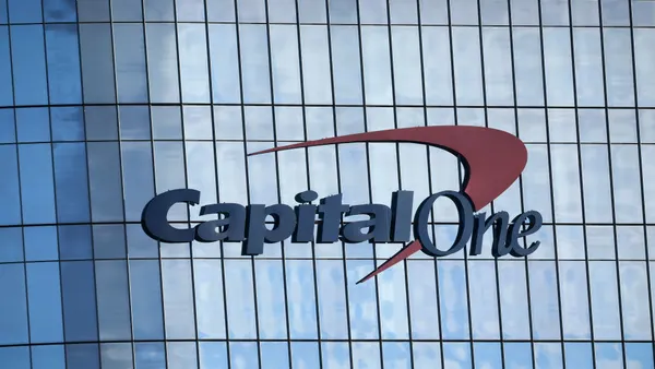 A close-up of a building with Capital One signage is shown.