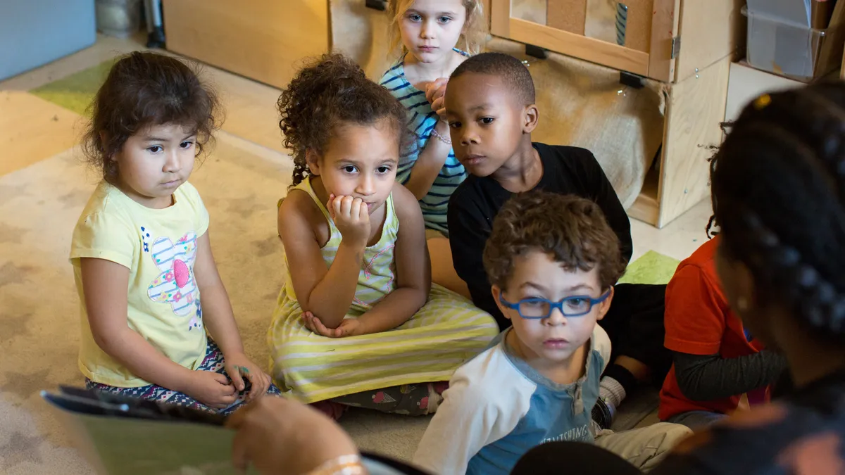 High schoolers from a Teaching 101 class practice their teaching skills with preschool students.