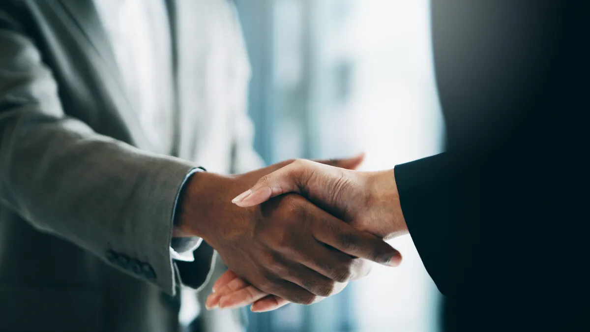 Closeup shot of two unrecognisable businesspeople shaking hands in an office