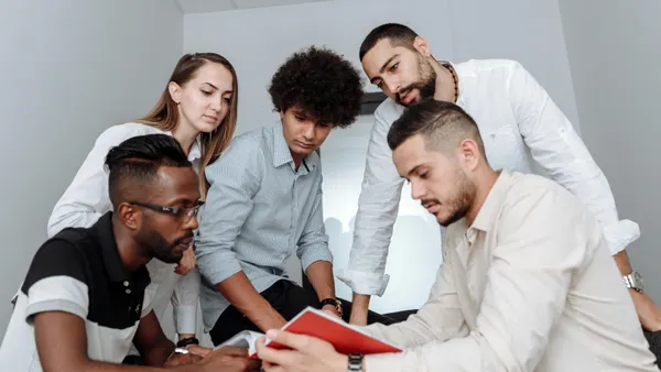 A multi-ethnic group of try to solve a problem