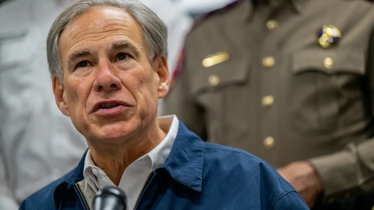 Texas Gov. Greg Abbott speaks at a microphone.