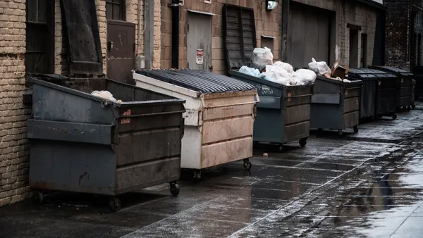 Line of dumpsters in alley