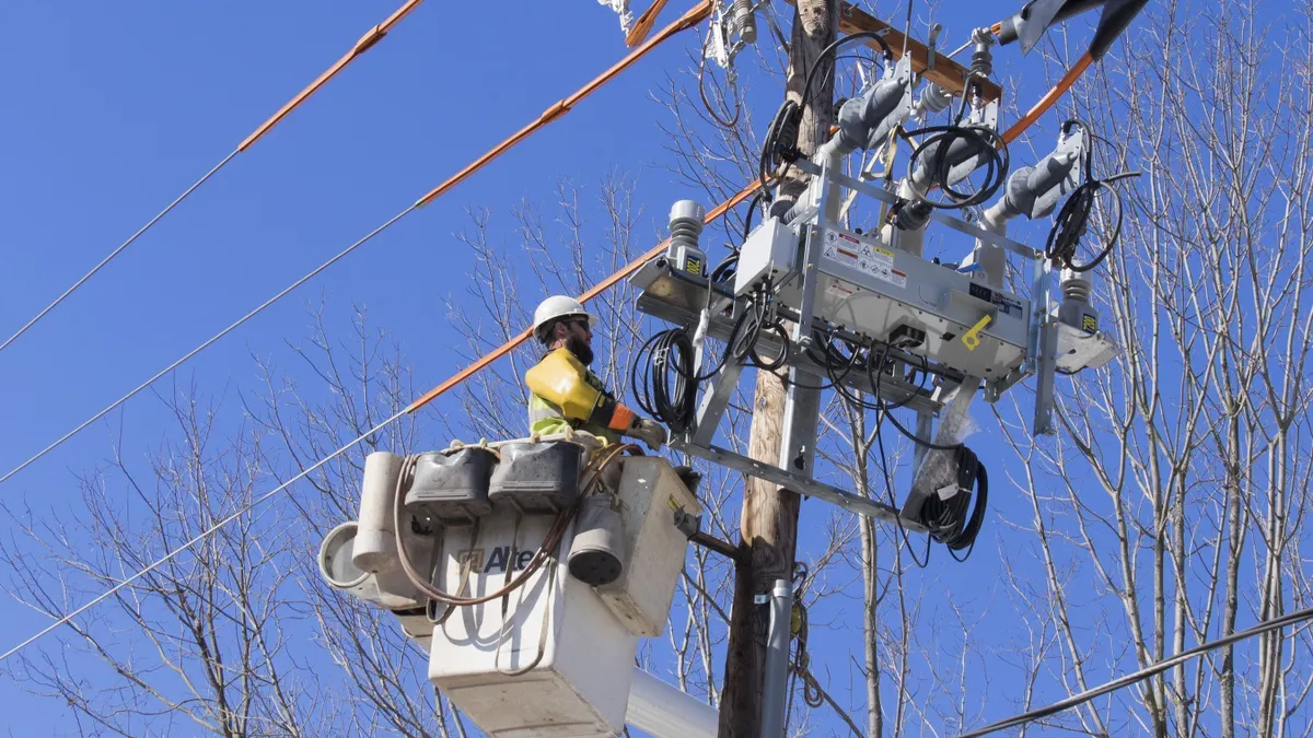 An electric utility lineman works on a power line.