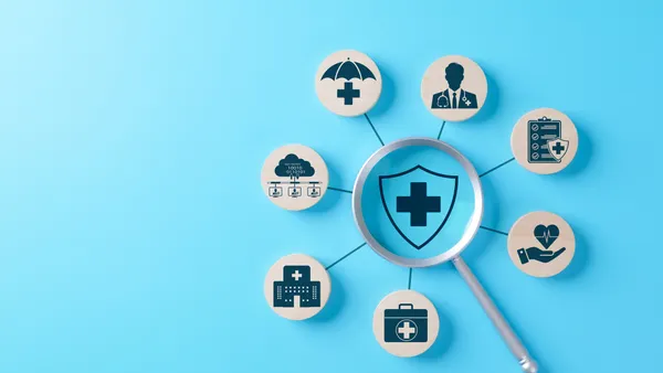 Health Insurance and Medical Care Concept. Magnifying glass focuses on shield featuring medical cross, surrounded by icons, medical care, health insurance, healthcare services, protection, coverage,
