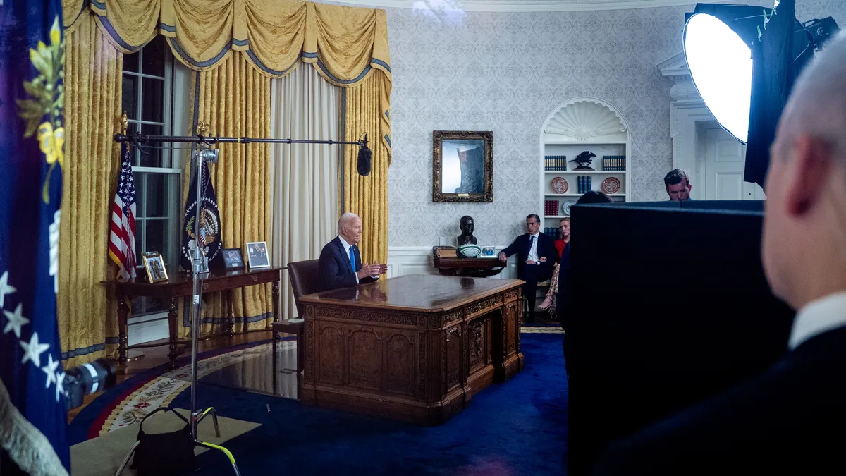 Image of President Biden sitting at his desk in the Oval Office on July 24 addressing the nation about his decision to not seek reelection.