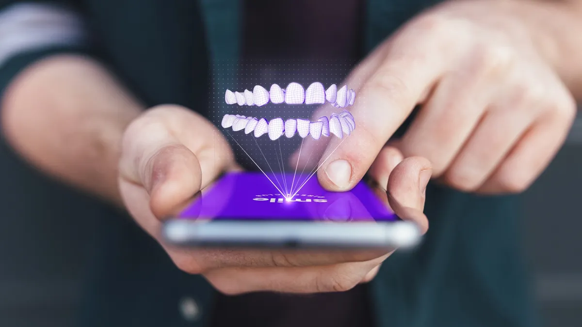 A 3D rendering of a mouth above a phone from SmileDirectClub