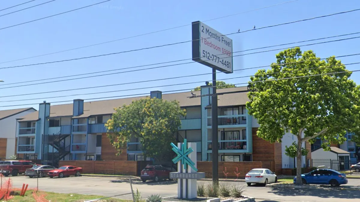 Garden apartments with parking lot in the foreground