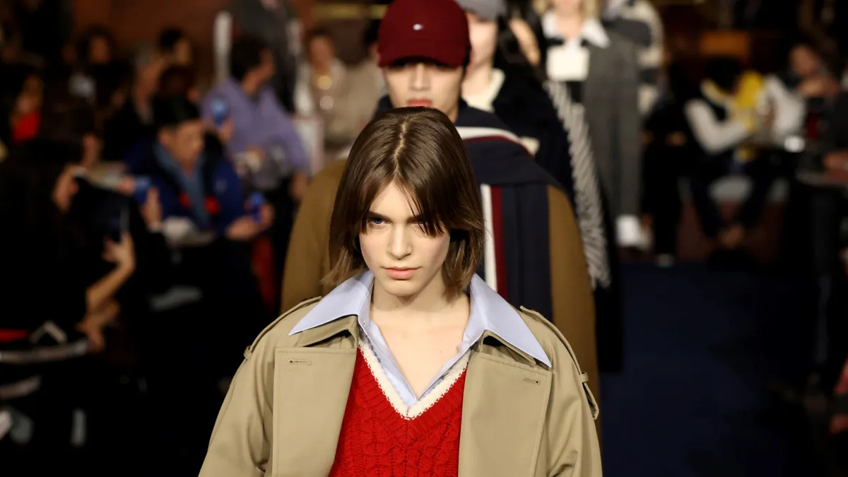 Models walk the runway wearing Tommy Hilfiger clothing.