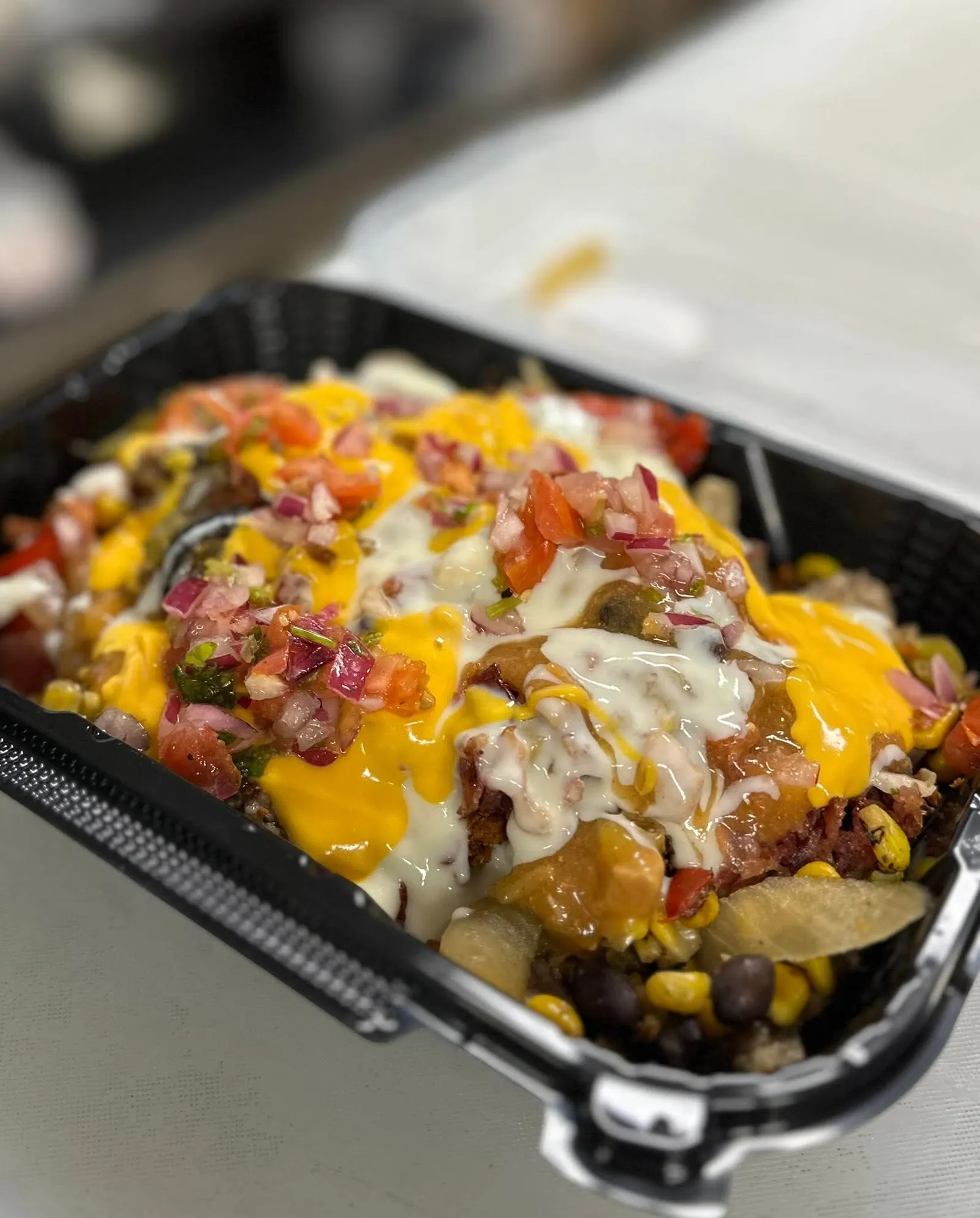 A close up of a burrito bowl in a disposable container.