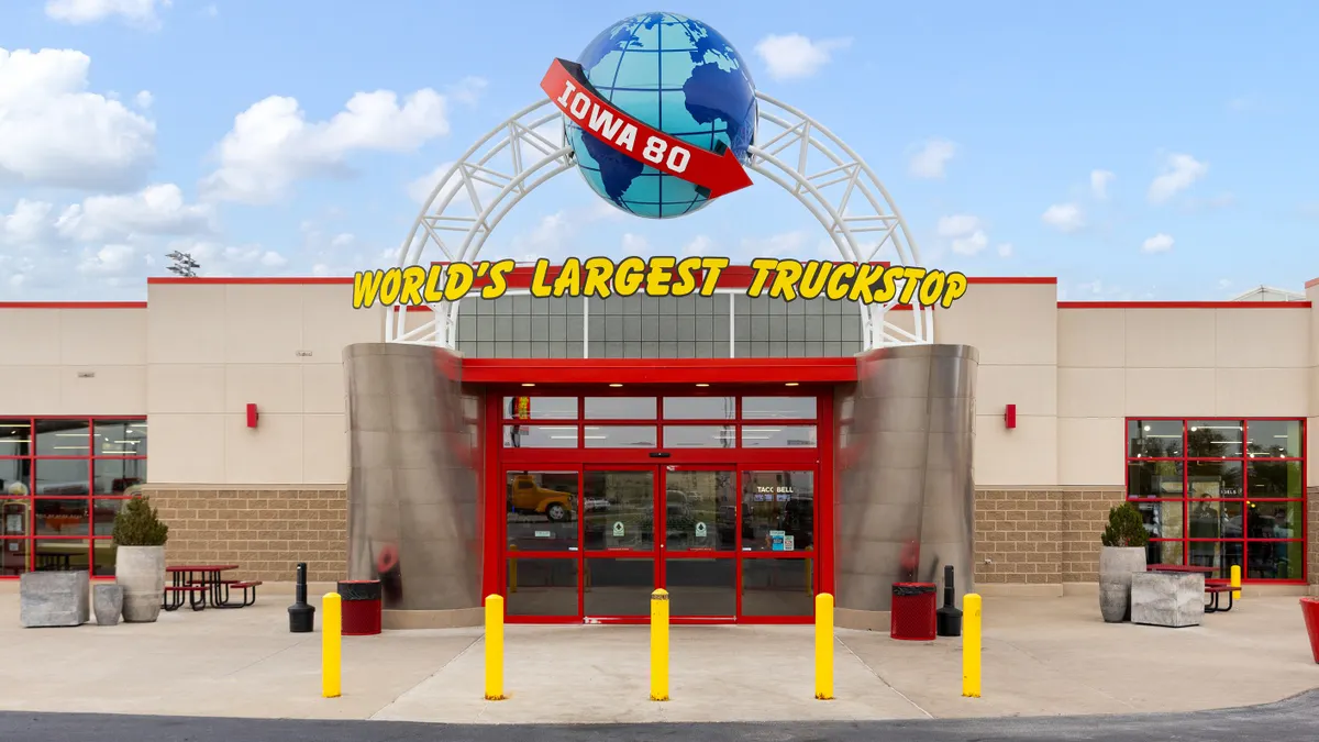 The entrance to a truck stop. A sign over the door says Iowa 80 World's Largest Truck Stop