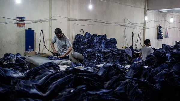 Men seen working in a clothing factory.