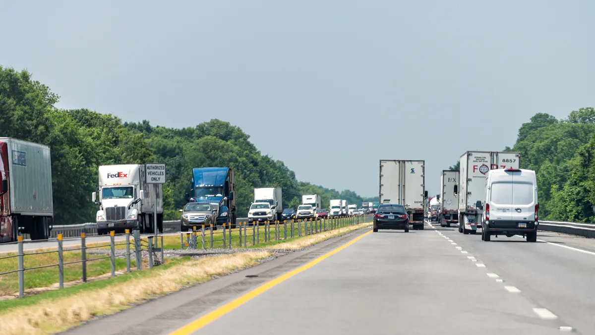 An interstate road on Arkansas with heavy traffic of cars and trucks.