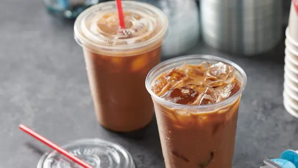 Two beverages in cups on the counter